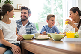 family with young children eating breakfast